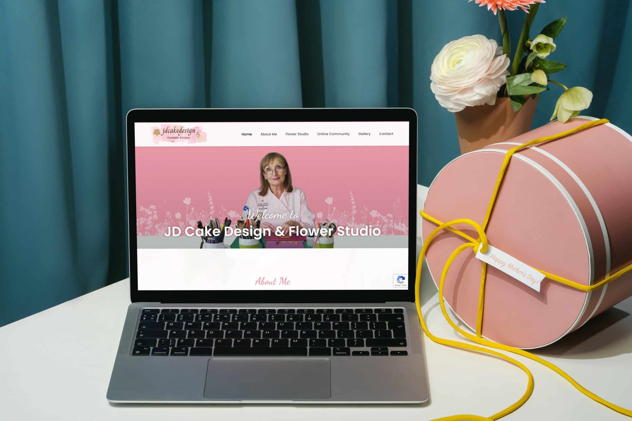 Mockup of JDCake design on laptop